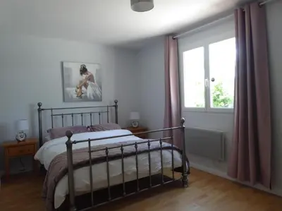 a bedroom with a bed and a window at La Maison Barthélemy: Voie Verte et piscine in Bellegarde-du-Razès