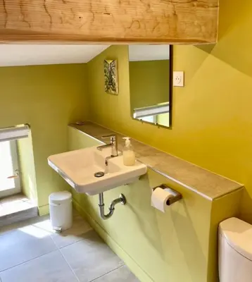 a bathroom with a sink and a mirror at La Souqueto in Mirepeisset