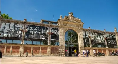 a building with a mural of faces on it at Studio au cœur du quartier historique in Narbonne