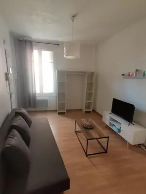 a living room with a couch and a coffee table at Studio au cœur du quartier historique in Narbonne