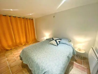 a bedroom with a bed with a pillow on it at Appartements cocons dans les Corbières in Villesèque-des-Corbières