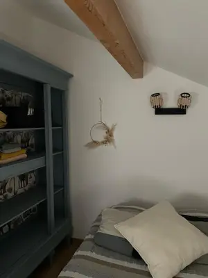 a bedroom with a bed and a book shelf at La Bergerie in Saint-Vincent