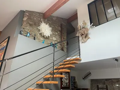 a staircase in a house with a stone wall at La Bergerie in Saint-Vincent