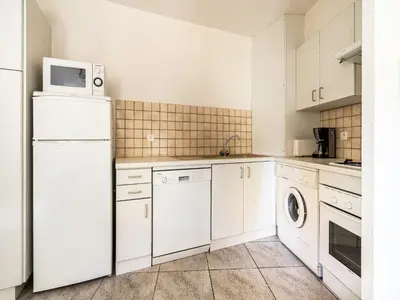 a kitchen with a white refrigerator and a microwave at Vineyards & Village Stay in Minerve