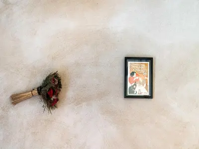 a picture hanging on a wall with a wreath at Vineyards & Village Stay in Minerve