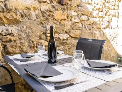 a table with a bottle of wine on top of it at Vineyards & Village Stay in Minerve