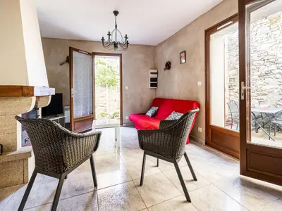 a living room with a red couch and chairs at Vineyards & Village Stay in Minerve