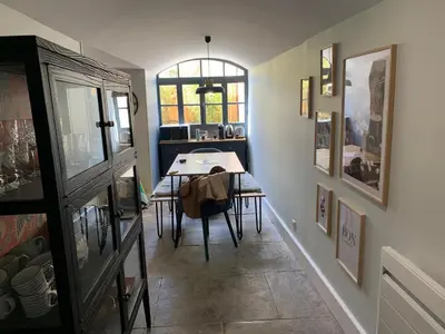 a dining room with a table and a window at Dans ma Bulle - Les Balcons de la Cité in Carcassonne