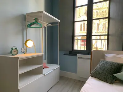 a bedroom with a bed and a desk and a window at Dans ma Bulle - Les Balcons de la Cité in Carcassonne