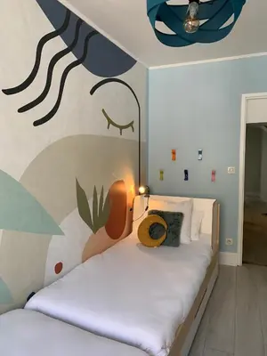 a bedroom with a bed with a mural on the wall at Dans ma Bulle - Les Balcons de la Cité in Carcassonne