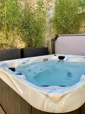 a jacuzzi bath tub with blue water in it at Dans ma Bulle - Les Balcons de la Cité in Carcassonne