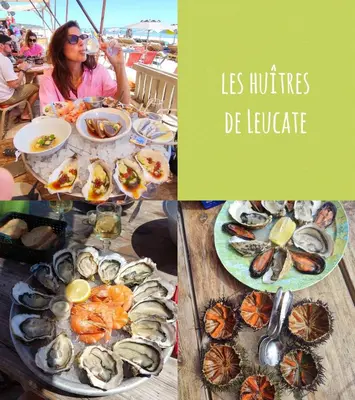 a table with plates of seafood and a woman eating at Jolie maison village 4 couchages &Terrasse à Fitou in Fitou