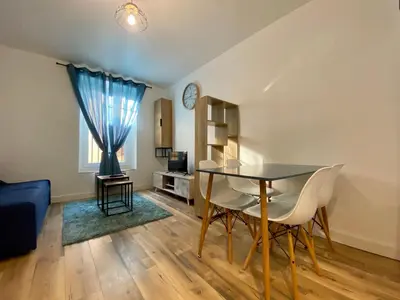 a living room with a glass table and chairs at Zen appart - 35m2 à Carcassonne in Carcassonne