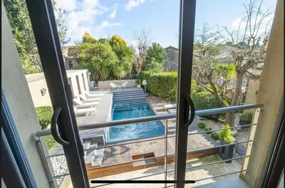 a view of a swimming pool from a window at House Avenue in Carcassonne