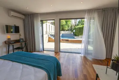 a bedroom with a bed and a sliding glass door at House Avenue in Carcassonne