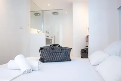 a bag sitting on top of a bed with towels at House Avenue in Carcassonne