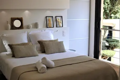 a bedroom with a large white bed with a window at House Avenue in Carcassonne