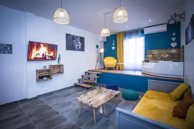 a living room with a couch and a table at Au Canal du Midi - Appartements au cœur de la ville in Carcassonne