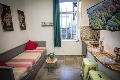 a small room with a couch and a window at Au Canal du Midi - Appartements au cœur de la ville in Carcassonne