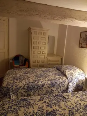 a bedroom with a bed and a dresser and a bed sidx sidx sidx sidx at L'OCCITANE appartement climatisé centre ville in Limoux