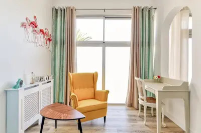 a room with a chair and a desk and a window at Loft Plage du Grazel in Gruissan