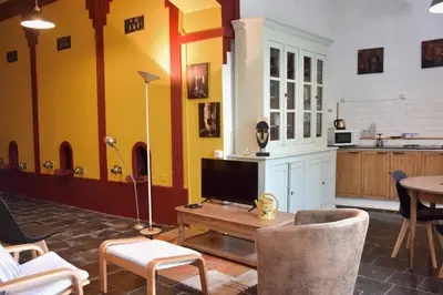 a living room with a tv and a table at LE PETIT CLOS in Fontjoncouse