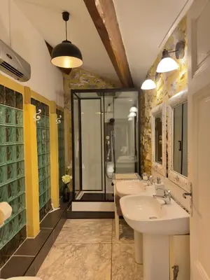 a bathroom with three sinks and a shower at LE PETIT CLOS in Fontjoncouse