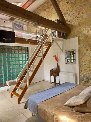 a bedroom with a staircase and a bed in a room at LE PETIT CLOS in Fontjoncouse