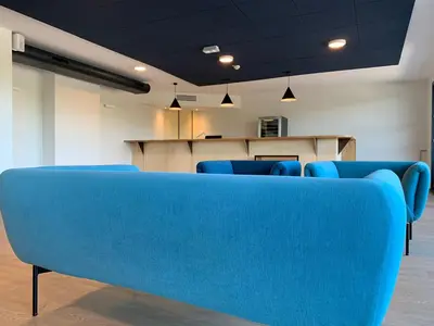 a blue couch in a waiting room at CIS Lamourelle Centre International de Sejour in Carcassonne