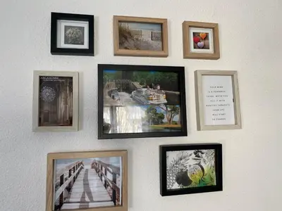 a wall with framed pictures on a wall at Best cocooning au calme avec parking privé in Carcassonne