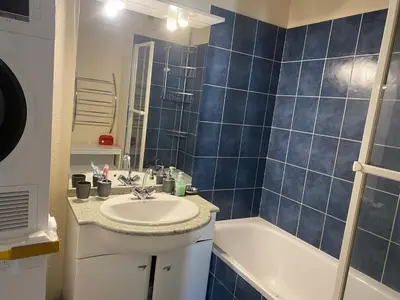 a blue tiled bathroom with a sink and a tub at Best cocooning au calme avec parking privé in Carcassonne