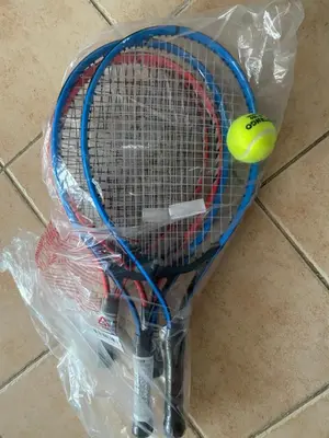 a tennis racket and a tennis ball in a plastic bag at Best cocooning au calme avec parking privé in Carcassonne