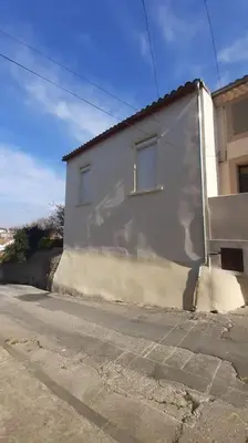 a white building on the side of a street at Le Logis du Moulin Gîte avec Jacuzzi, à 800m de la Cité Médiévale in Carcassonne