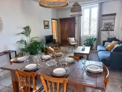 a living room with a blue couch and a coffee table at Le Logis du Moulin Gîte avec Jacuzzi, à 800m de la Cité Médiévale in Carcassonne