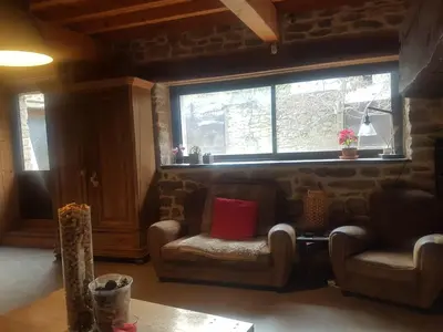 a living room with two chairs and a window at Villa Misanid écrin de verdure à 15mm de la cité de Carcassonne in Mas-des-Cours