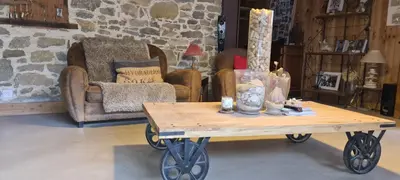 a coffee table in a living room with a couch at Villa Misanid écrin de verdure à 15mm de la cité de Carcassonne in Mas-des-Cours