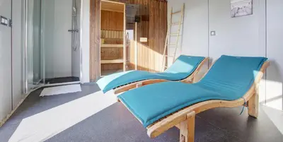a pair of chairs sitting in a room at Mobil Home XXL 4 chambres - Camping Le Barberousse in Gruissan