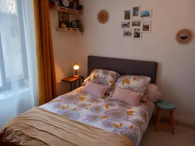 a bedroom with a bed with two pillows on it at Studio mirabeau les halles 15m2 climatisation in Narbonne
