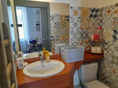 a bathroom with a sink and a toilet and a mirror at Studio mirabeau les halles 15m2 climatisation in Narbonne