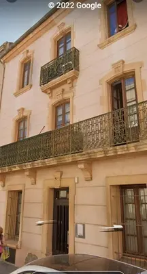 a building with a balcony on top of it at Studio mirabeau les halles 15m2 climatisation in Narbonne