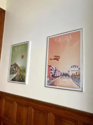 two pictures hanging on a white wall at La Grande Maison Mazamet in Mazamet