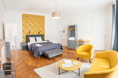 a bedroom with a bed and a living room at La Grande Maison Mazamet in Mazamet