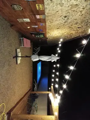 a white umbrella hanging from a ceiling with lights at maison a bizanet avec piscine in Bizanet