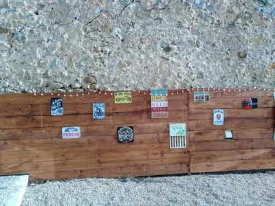 a wooden wall with many stickers on it at maison a bizanet avec piscine in Bizanet