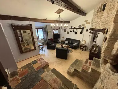 an aerial view of a living room with a stone wall at Chez Nath et Oli in Caunes-Minervois