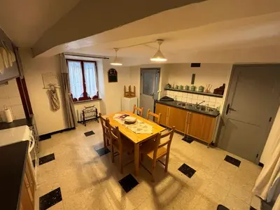 a kitchen with a table and chairs in a room at Chez Nath et Oli in Caunes-Minervois