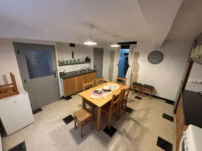 a kitchen and dining room with a table and chairs at Chez Nath et Oli in Caunes-Minervois