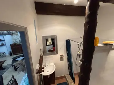 a bathroom with a sink and a mirror at Chez Nath et Oli in Caunes-Minervois