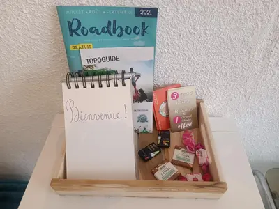 a book and a notebook and some other items on a table at Studio Gruissan La Presqu'île 2 in Gruissan