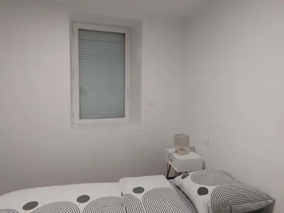 a white room with a bed and a window at bel appart T2 confortable en plein coeur de Sigean in Sigean